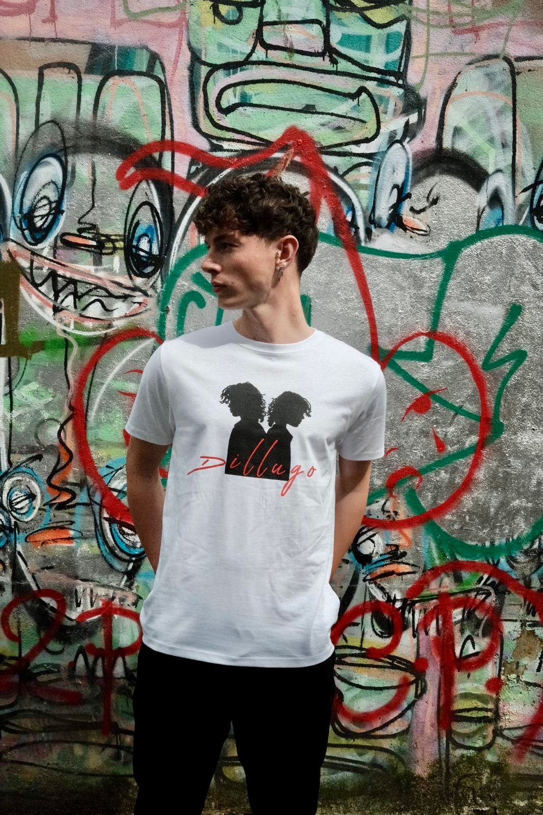 Male model looking right wearing white t-shirt with "Dillugo" written across it (in red) and the signature Dillugo silhouette, on a graffiti backdrop.